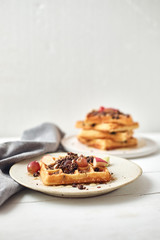 Homemade waffles with fruit and granola..