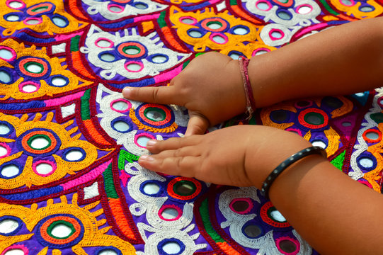embroidery mirror work on little baby hand,traditional embroidery in Gujarat,handmade ahir embroidery,India embroidery