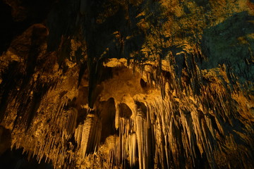 Stalactite and Stalagmite hanging from ceiling in the cave