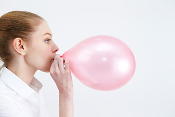 Caucasian woman blowing a balloon  © mnimage