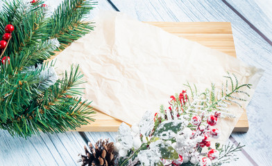 Christmas wooden background with spruce branches and red berries