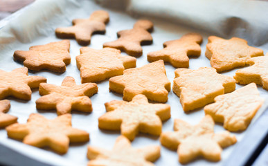 Delicious freshly baked Christmas cookies on a baking sheet.