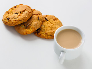 Cup of coffee with milk. Raisin cookies