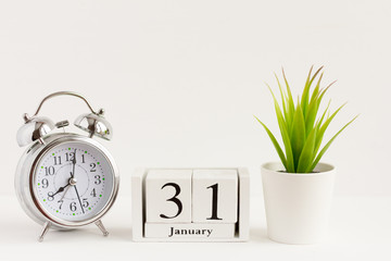 January 31 on a wooden calendar next to the alarm clock.Calendar date, holiday event or birthday.The concept of one day of the month.