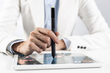 Fototapeta premium Man in business suit using tablet computer