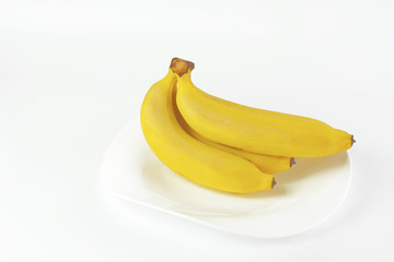 Gros Michel banana put on  white ceramic plate over white background. Concepts of healthy fruit....