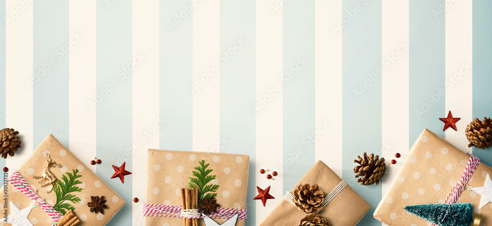 Wall mural Handmade Christmas gift boxes with ornaments - flat lay