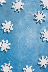 Christmas and New Year pattern made of snowflakes on a blue background with stars. Christmas, winter, new year concept. Flat lay, top view, copy space