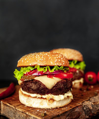two Tasty grilled burgers on a stone background