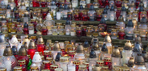 Monument and candles in the cemetery. All Saints Day in Poland. A lot of funeral candles.