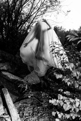 Slender nude girl, covered by a cellophane film, through which only her silhouette is visible and...