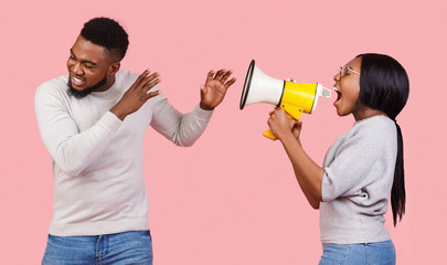 African american girl shouting through megaphone at her boyfriend