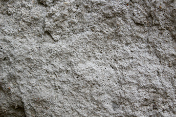 The rough surface of the stone is gray.