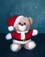 Christmas card with a toy bear dressed as Santa Claus close-up