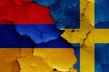 flags of Armenia and Sweden painted on cracked wall