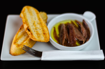 delicious Spanish snack, fresh fish marinated in olive oil, served with croutons