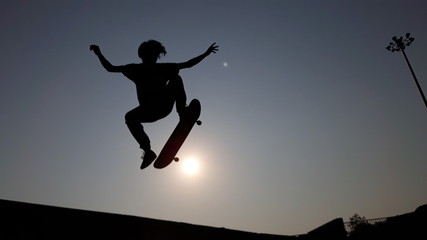 Fototapeta na wymiar silhouette of man jumping on a background of blue sky