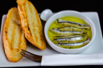 delicious Spanish snack, fresh fish marinated in olive oil, served with croutons