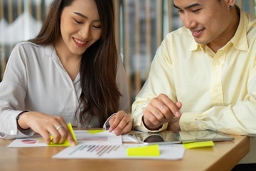 Happy Asian couples be smile after calculating income And expenses because it receives profits from investments. Concepts for investment planning and financial planning for the family.