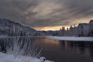 Russia. mountain Altai. Biya river near the source of lake Teletskoye. Winter dawn over the Siberian river
