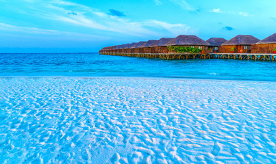 Wooden bridges leading to the huts on the shores of the tropical