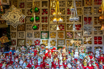 Variety of tiny Christmas figures and Christmas baubles in a market stand on a German Christmas market