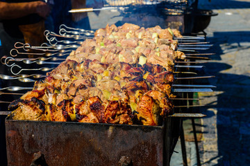 Skewers with meat over the charcoals. Cooking shashlik