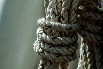Fototapeta na wymiar Strong wound rope. White twisted anchor halyard