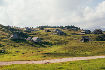 Fototapeta na wymiar Farmer houses - Velika Planina, Slovenia. Beautiful place with pastures around.