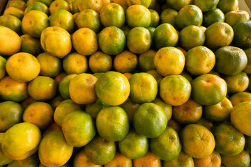 orange fruit stacked on the marketplace