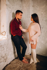 Romantic evening of a young couple. New Year's love story. Photo session of lovers in the studio.