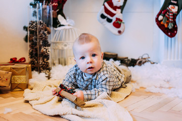 Fototapeta premium Little boy with christmas gift box. Merry Christmas and Happy Holidays!