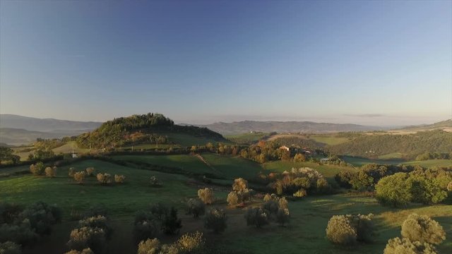 4k aerial  drone forward flight footage at early morning crazing light over the astonishing beauty of Tuscany countryside hills between Volterra and Cecina.