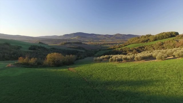 4k aerial  drone low fly footage over the green Tuscany countryside near Volterra.