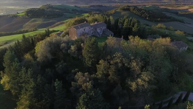 4k aerial  drone orbit flight footage over the Tuscany countryside small ancien village of Gello near Volterra.