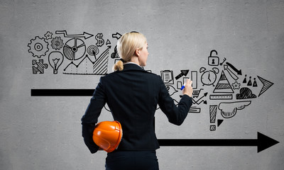 Businesswoman draws various business infographics