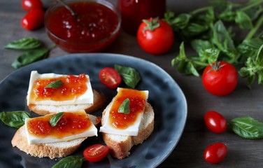 Jam from tomatoes with basil. toast with cheese and tomato jam. unusual jam. Turkish, French or Italian cuisine.