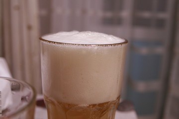 beer in a glass with foam