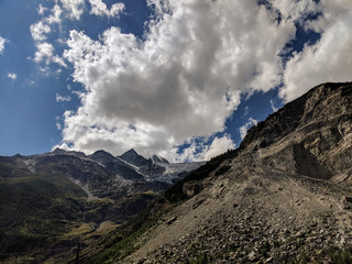 Mountain landscape with trail and cloudy sky.