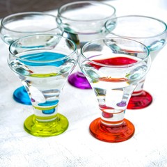 Colorful drinking glasses on white background