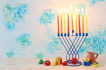 Religion image of jewish holiday Hanukkah background with menorah (traditional candelabra) and dreidels