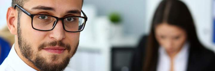 Obraz premium Handsome smiling bearded clerk man wearing glasses