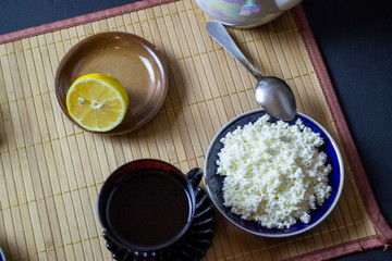 morning breakfast tea with cottage cheese and sweets on a serving board, top view
