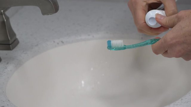  Toothbrush gets moistened and toothpaste - medium shot 4K