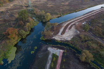 Fototapeta premium Environmental damage. Construction of a park on the river bank.
