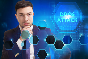 Business, Technology, Internet and network concept. Young businessman working on a virtual screen of the future and sees the inscription: Ddos attack