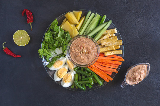 Indonesian gado-gado salad on a black background