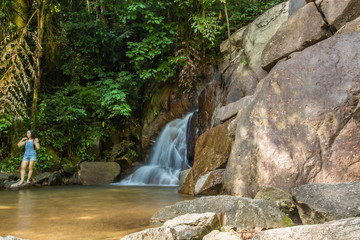 Fototapeta na wymiar Kathu Waterfall in the tropical forest area In Asia, suitable for walks, nature walks and hiking, adventure photography Of the national park Phuket Thailand,Suitable for travel and leisure.