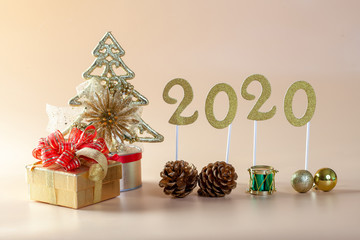 2020 year golden and and Christmas decorations on a orangebackground