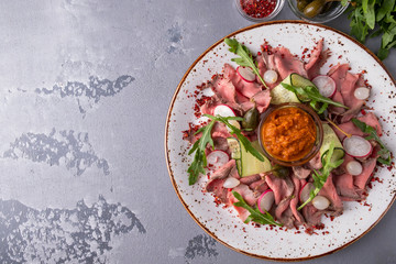 Cold snack with roast beef slices and  vegetables. Copy space. Top view.